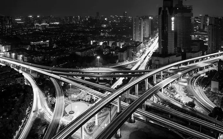 Motorway interchange at night traced with light trails