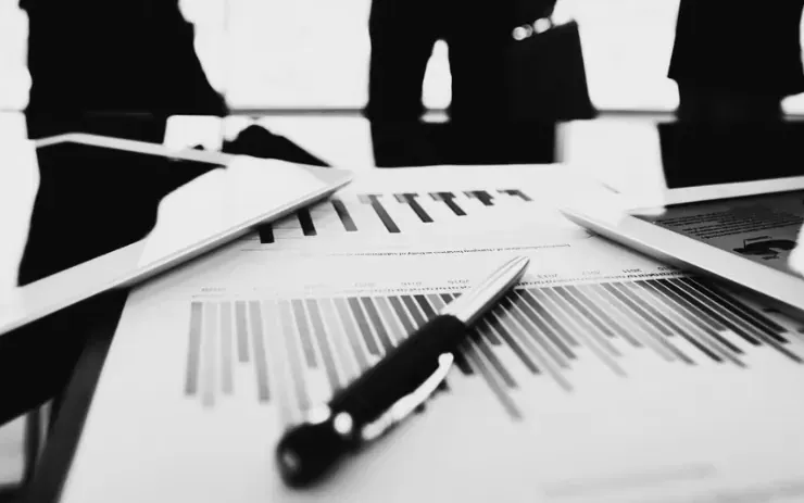 Signed transaction documents on a boardroom table