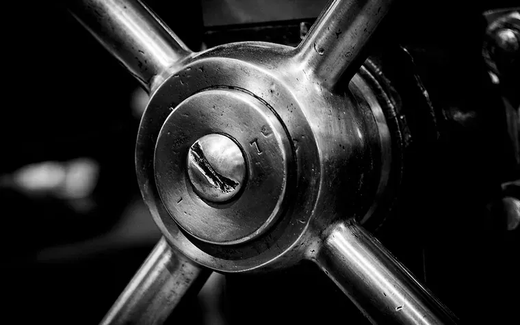 A heavy spoked steel wheel, close up