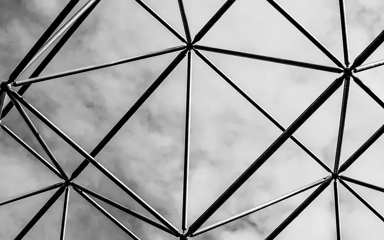 Triangulated glazed dome seen from below against cloud