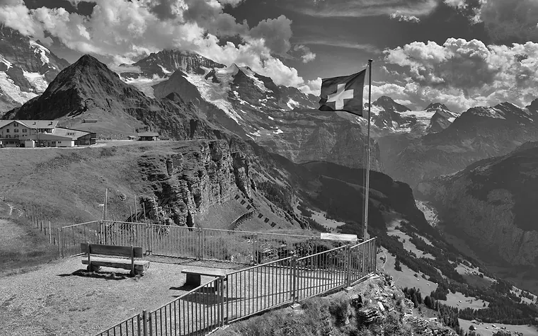 Swiss flag flying at an alpine viewpoint