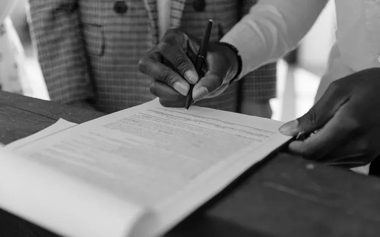 Hand signing a multi-page agreement