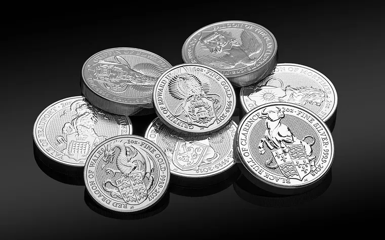 Bullion coins arranged on a dark surface
