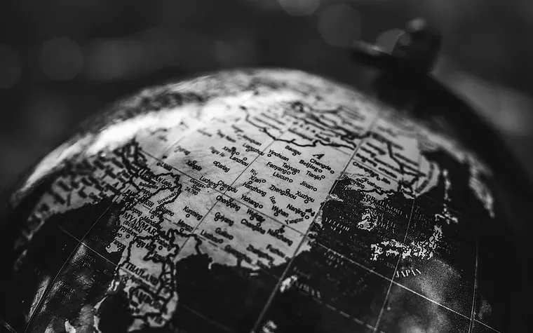 A globe under directional light, Asia and the Gulf turned to camera