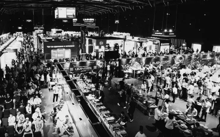 Crowded crypto conference hall seen from above