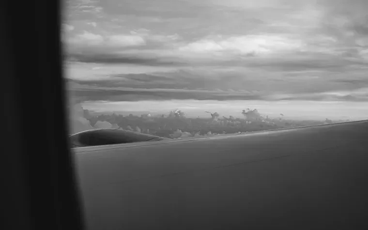 Aircraft wing above cloud at sunset