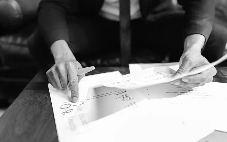 Hand marking figures on a financial statement