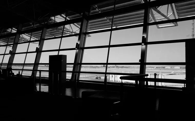 Airport terminal window overlooking an empty runway